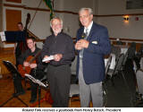 Roland Fink (l.) receives a yearbook from Henry Betsch, President of the Danube Swabian Club Scarborough
