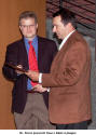 Dr. Frisse presents Paul J. Motz a plaque