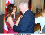 Miss Concordia pins the President