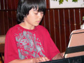 Cameron Miemiec plays the keyboard